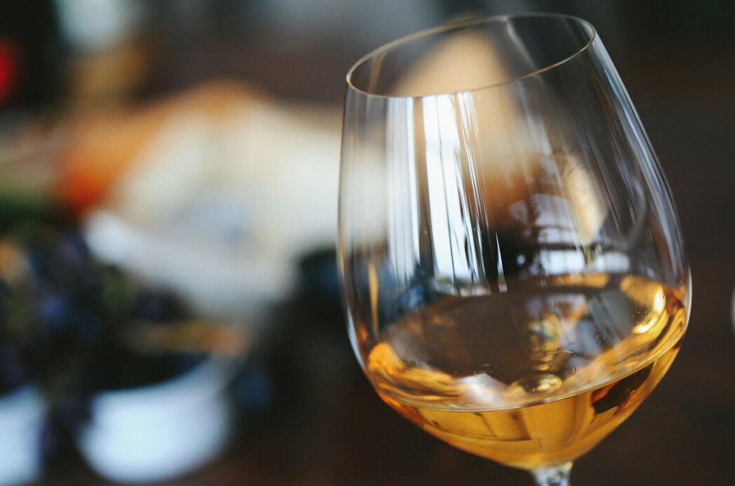White wine in a glass with the blurred background behind